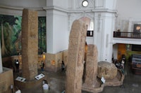 a group of people in a museum looking at statues